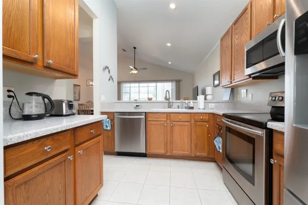a kitchen with stainless steel appliances granite countertop a sink and cabinets