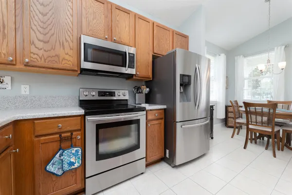 a kitchen with stainless steel appliances granite countertop a refrigerator stove and microwave