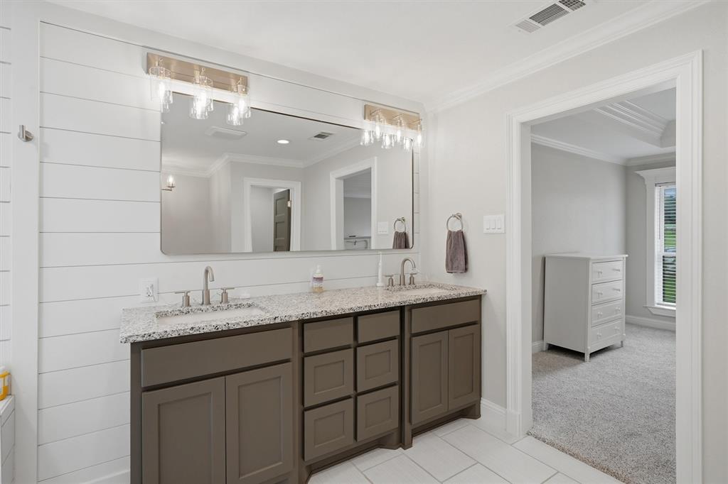 9121 Bontura Road Granbury, TX 76049 - Photo 19 of 40 Bathroom vanity featuring dual sinks with granite countertops and brushed nickel faucets