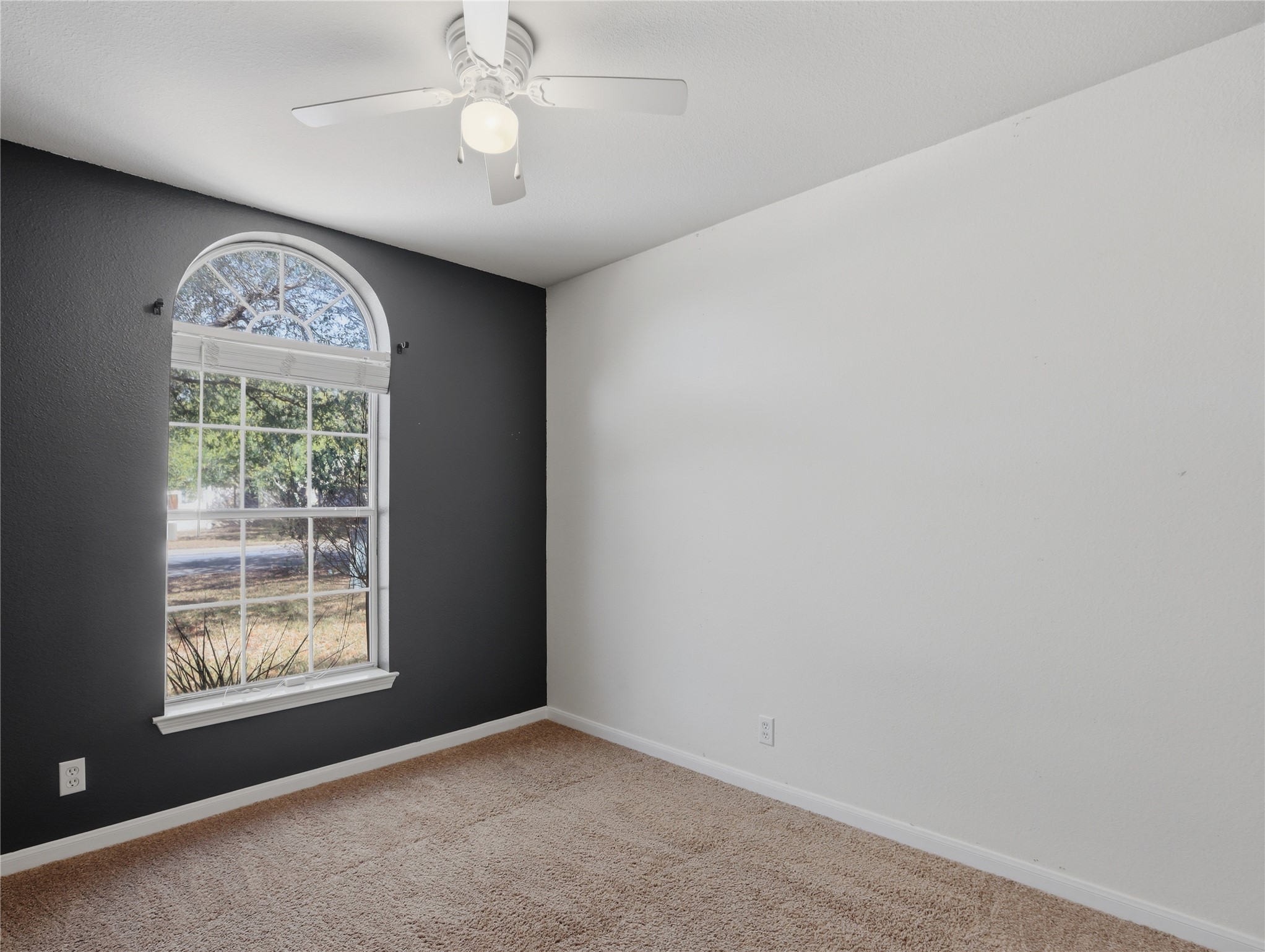 168 Keystone Loop Kyle, TX 78640 - Photo 12 of 23 Unfurnished room with light carpet and a ceiling fan