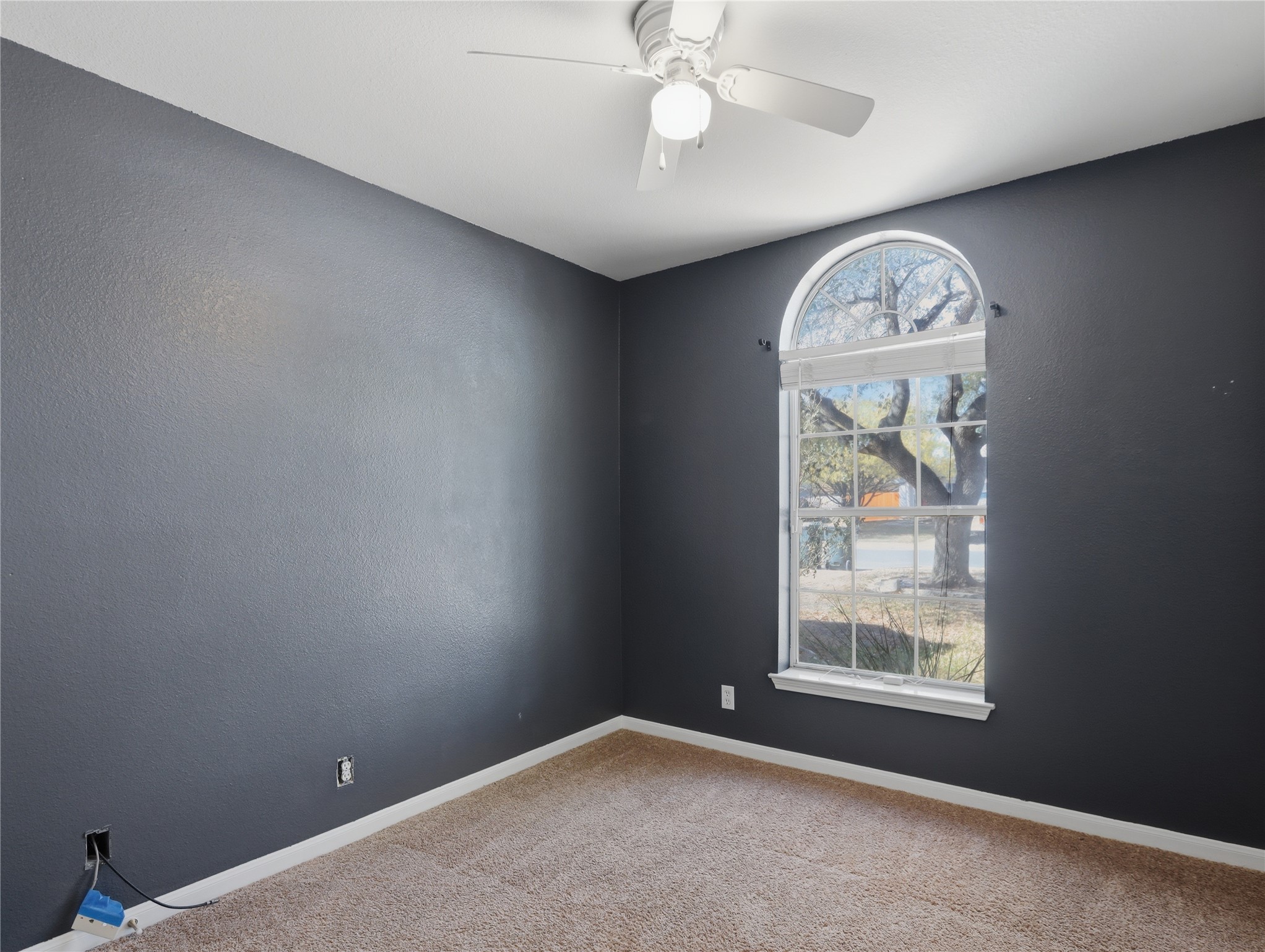 168 Keystone Loop Kyle, TX 78640 - Photo 13 of 23 Spare room with a ceiling fan, light carpet, and a textured wall