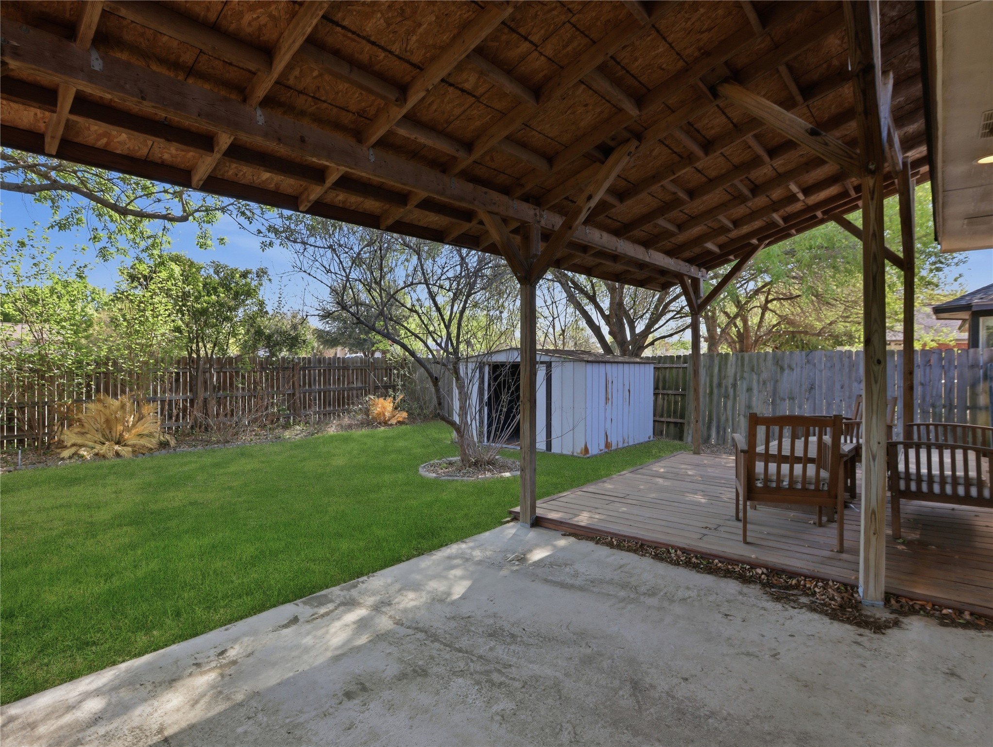 168 Keystone Loop Kyle, TX 78640 - Photo 20 of 23 Fenced backyard with a deck and an outdoor structure