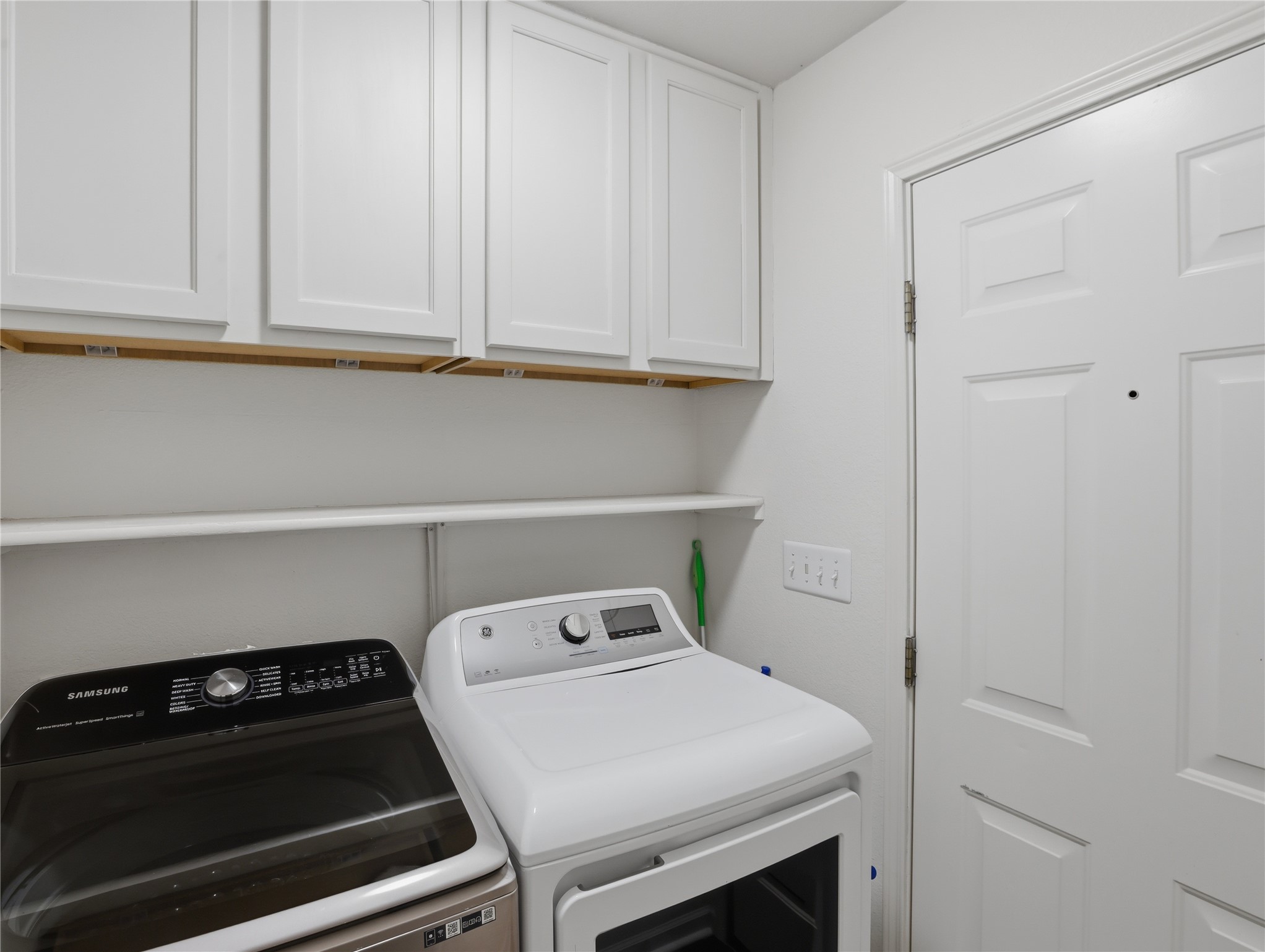 168 Keystone Loop Kyle, TX 78640 - Photo 22 of 23 Laundry room featuring separate washer and dryer and cabinet space