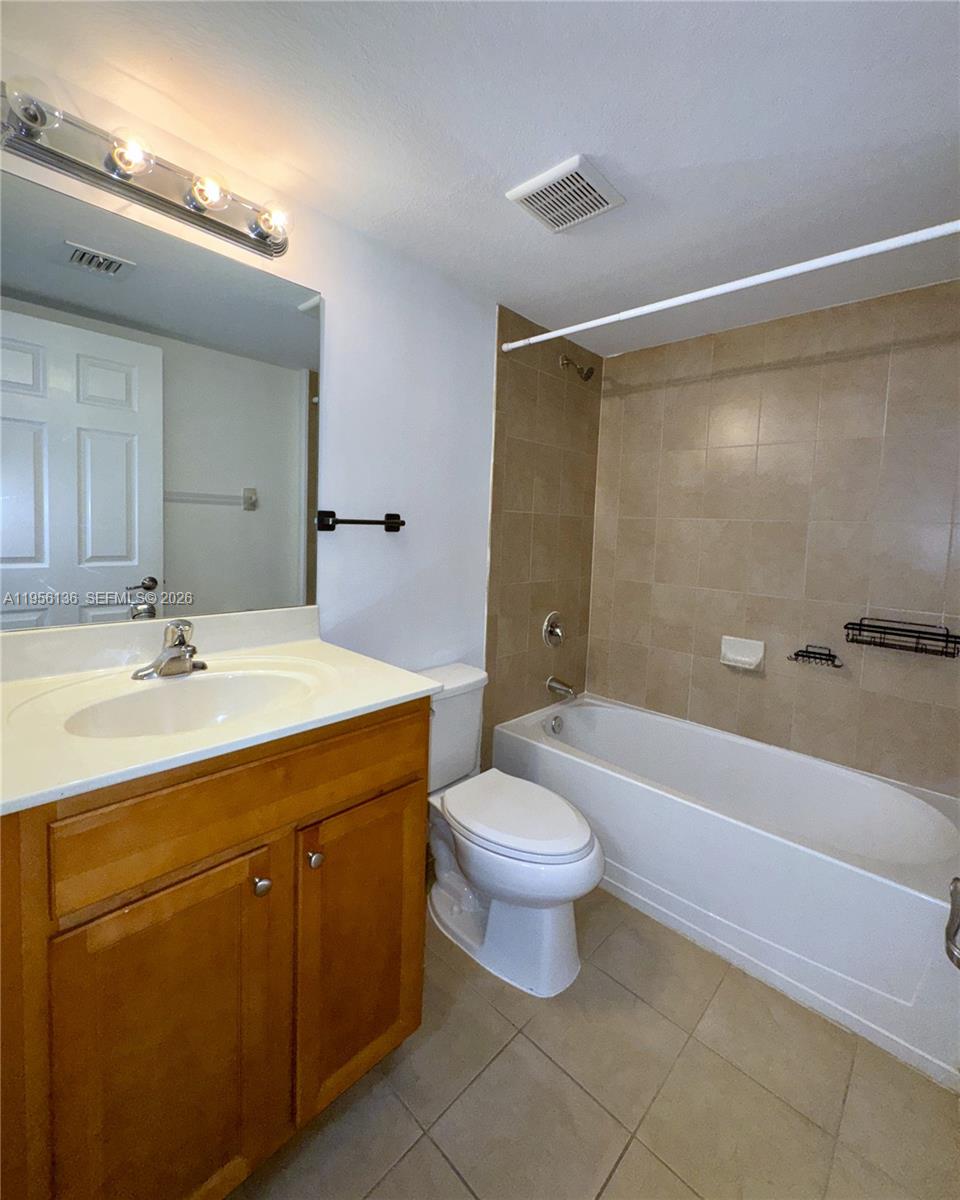 22441 Southwest 88th Place, Unit 2015 Cutler Bay, FL 33190 - Photo 11 of 19 a bathroom with a double vanity sink toilet and bathtub