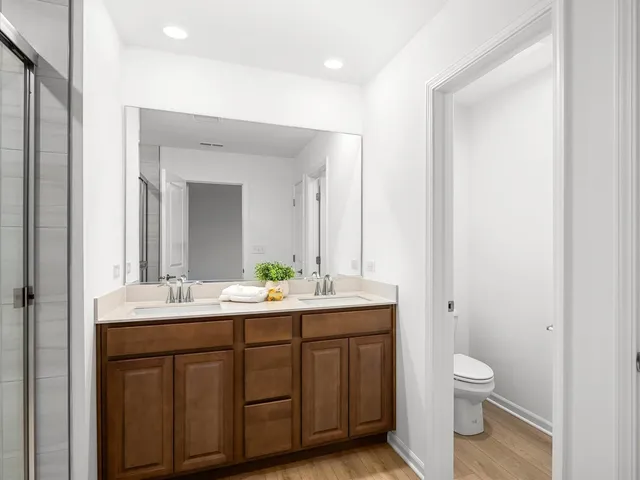 a bathroom with a toilet a sink a and mirror