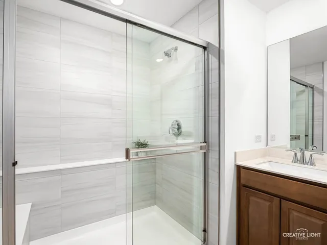 a bathroom with a shower and a sink