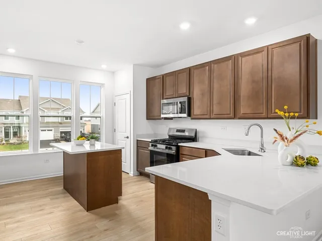 a kitchen that has a sink and a stove in it