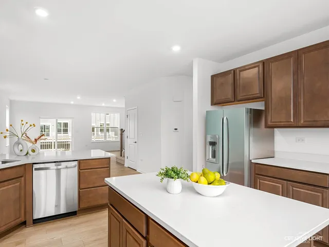 a kitchen with stainless steel appliances a sink a stove and a refrigerator