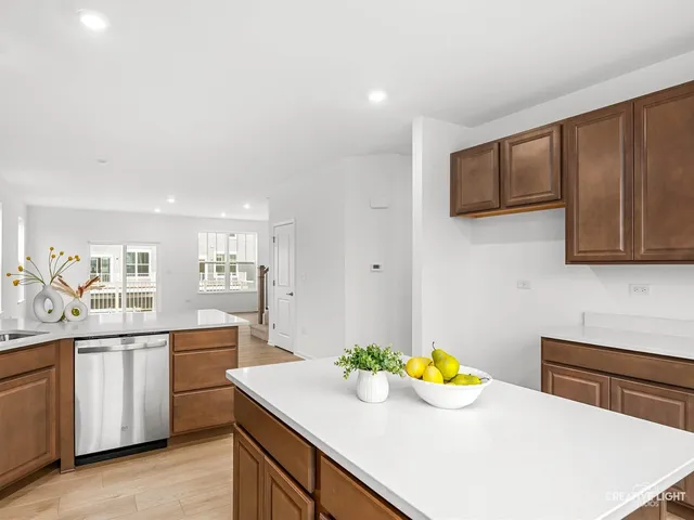 a kitchen with stainless steel appliances a sink a stove top oven a counter space and cabinets