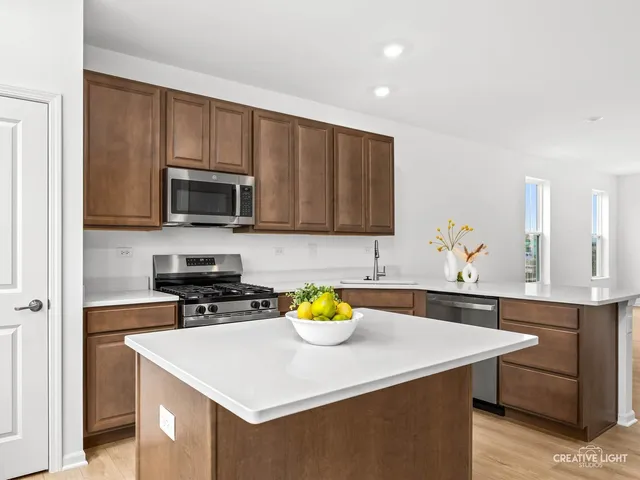 a kitchen with stainless steel appliances a sink a stove cabinets counter space and cabinets