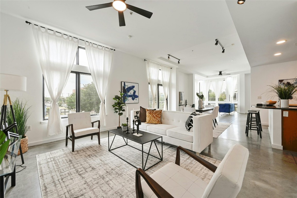 2124 East 6th Street, Unit 214 Austin, TX 78702 - Photo 1 of 1 a living room with furniture and a large window