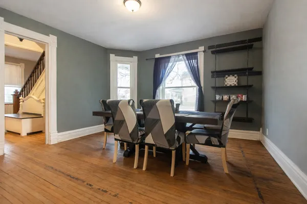 a view of a dining room with furniture and wooden floor