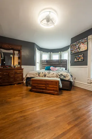a bedroom with furniture and a wooden floor