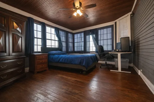 a living room with a bed furniture and a flat tv screen