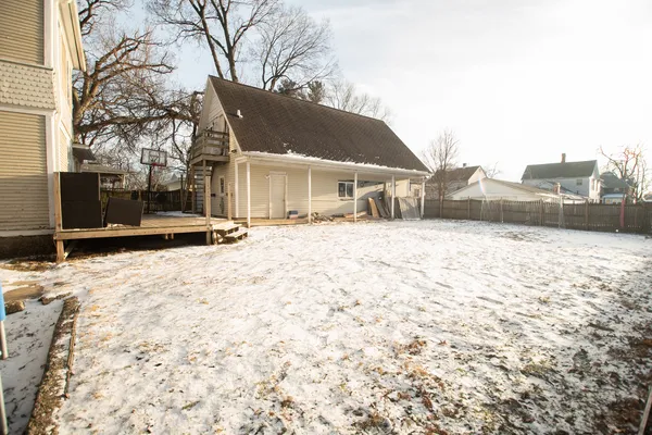 a view of a house with snow on the road