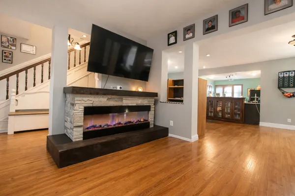 a living room with furniture a flat screen tv and a fireplace