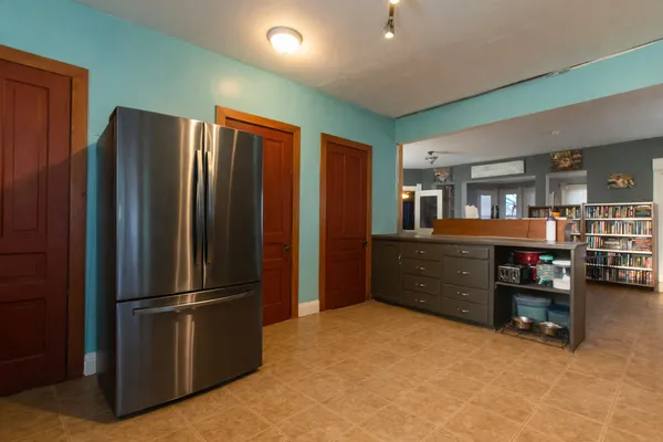a kitchen with refrigerator and cabinets