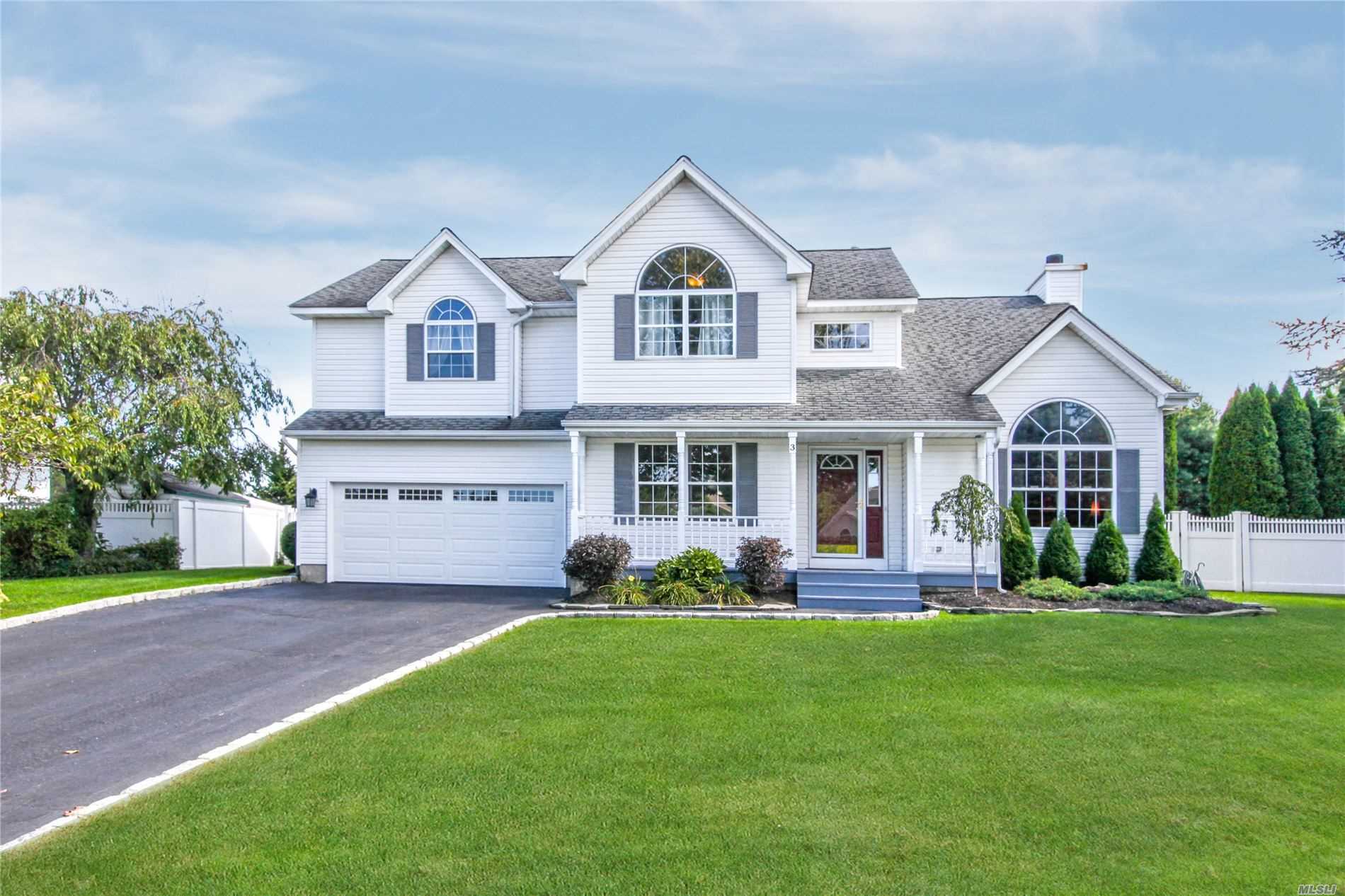 a front view of a house with a yard and porch