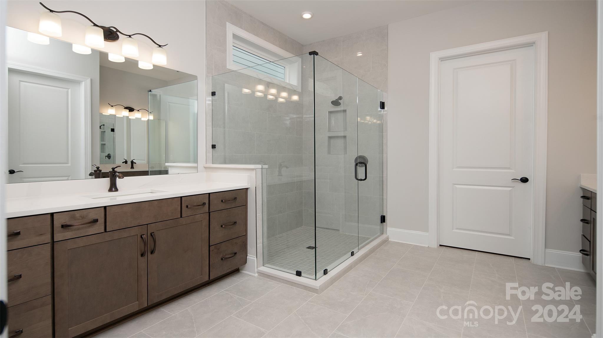 2002 Lake Como Drive Monroe, NC 28110 - Photo 13 of 40 a spacious bathroom with double sink shower and mirror