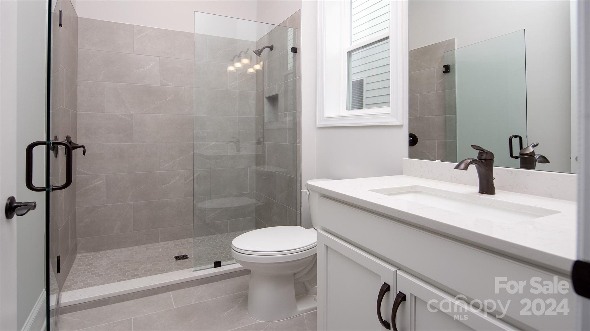 2002 Lake Como Drive Monroe, NC 28110 - Photo 16 of 40 a bathroom with a sink a toilet and shower
