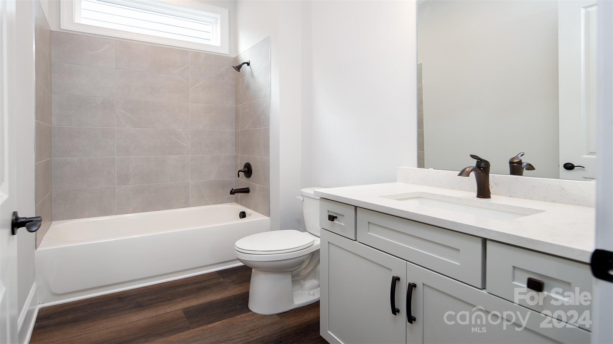 2002 Lake Como Drive Monroe, NC 28110 - Photo 20 of 40 a bathroom with a sink a toilet and bathtub