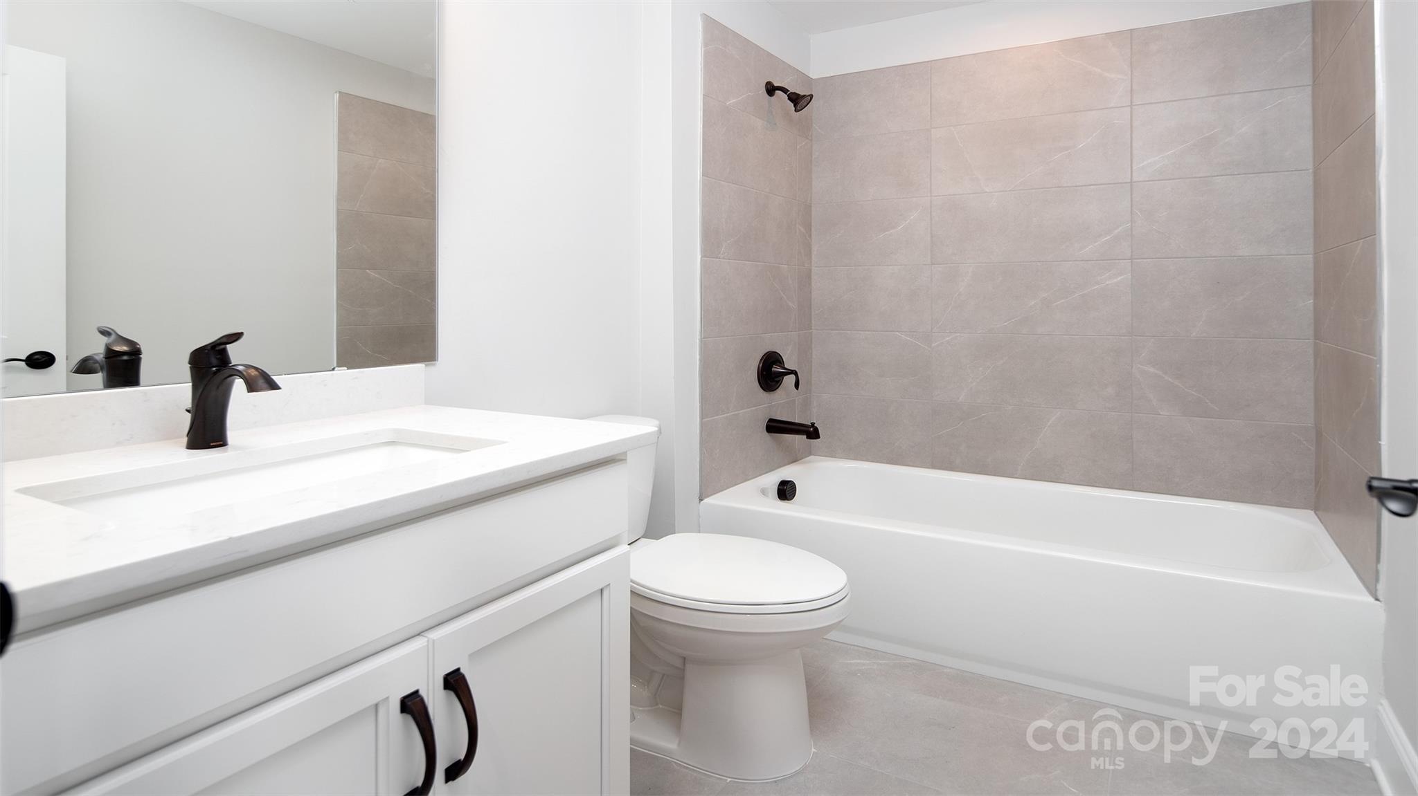 2002 Lake Como Drive Monroe, NC 28110 - Photo 26 of 40 a bathroom with a sink a toilet and a bathtub