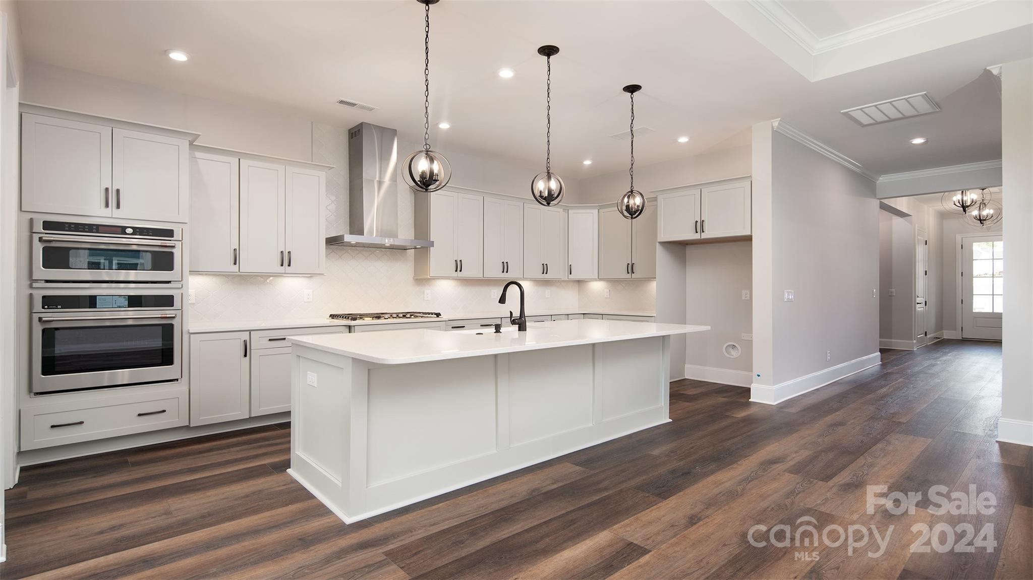 2002 Lake Como Drive Monroe, NC 28110 - Photo 4 of 40 a kitchen with kitchen island a sink stainless steel appliances and cabinets