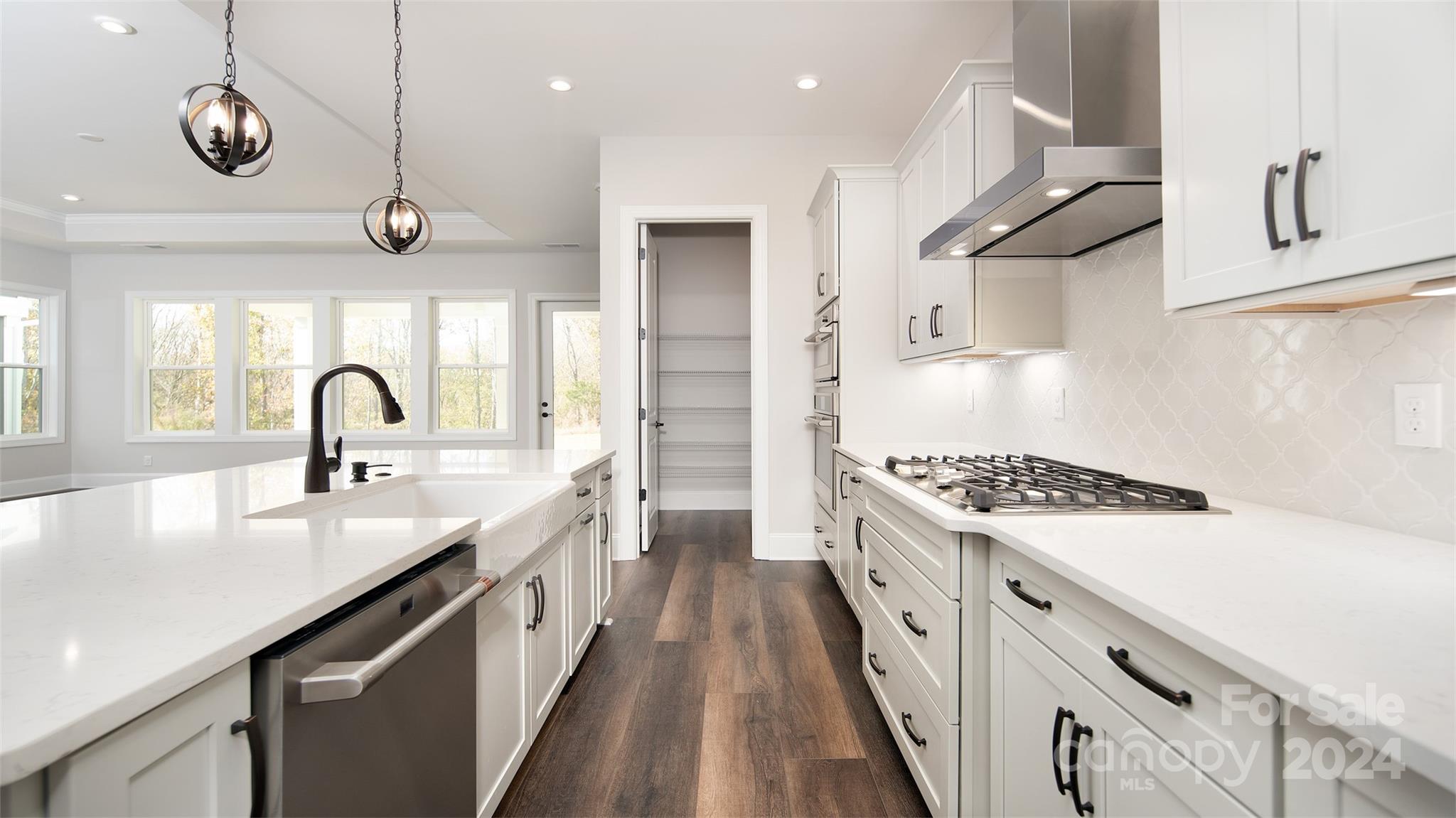 2002 Lake Como Drive Monroe, NC 28110 - Photo 6 of 40 a kitchen with stainless steel appliances granite countertop a sink a stove and a wooden floors