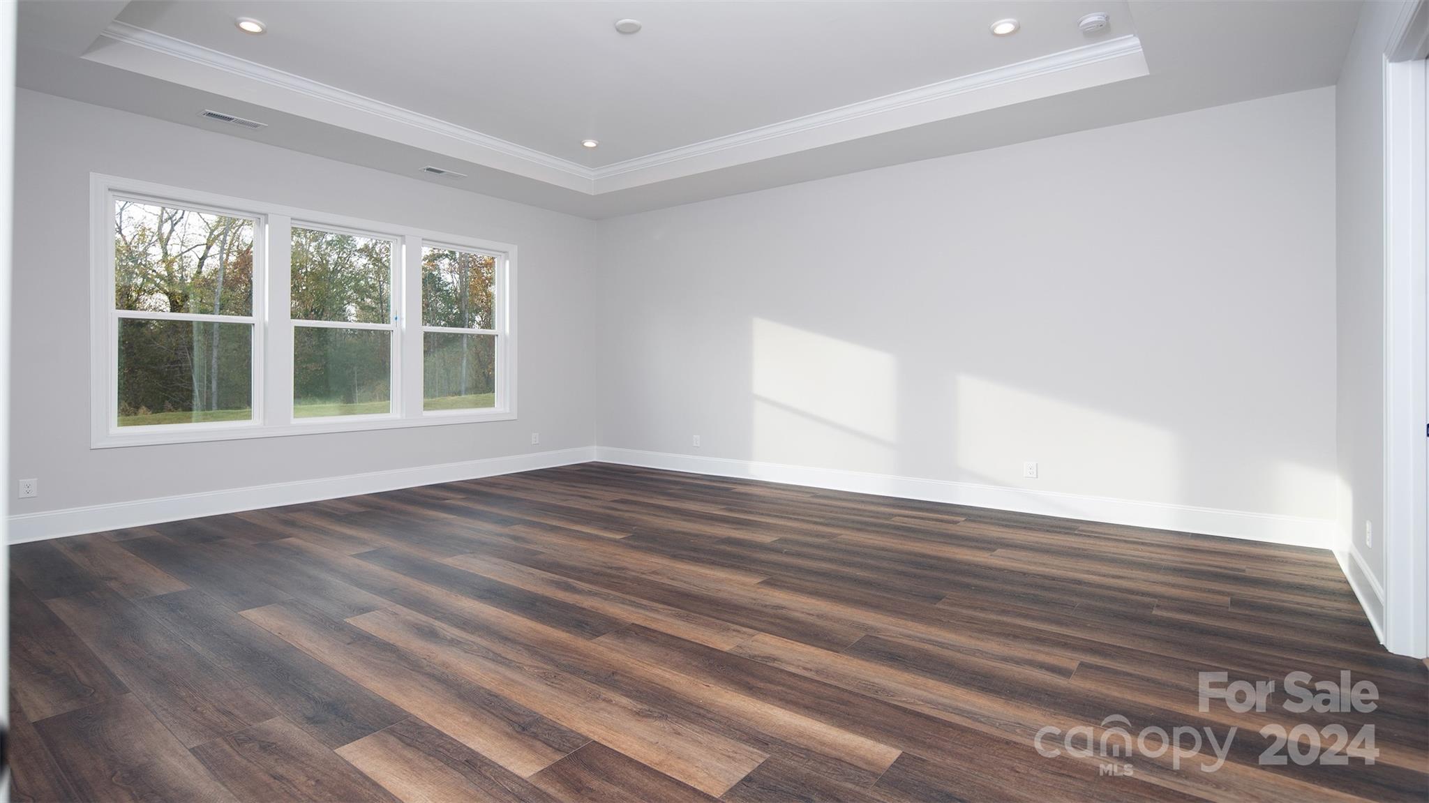 2002 Lake Como Drive Monroe, NC 28110 - Photo 8 of 40 a view of empty room with wooden floor and fan