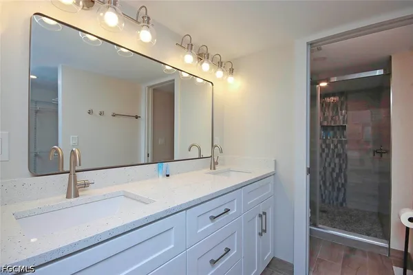 a bathroom with a sink double vanity and shower