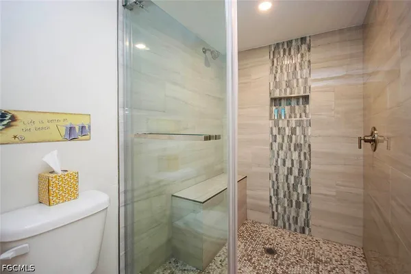 a bathroom with a shower and a toilet