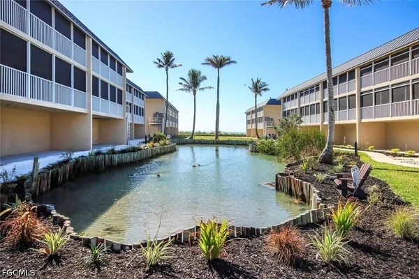 a view of a swimming pool with a lawn chairs under an umbrella
