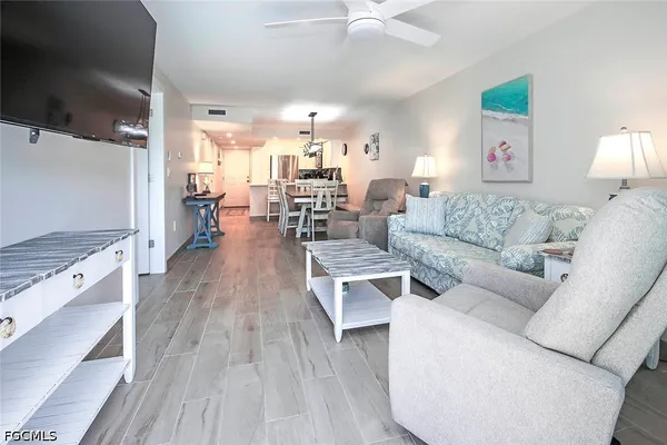 a living room with furniture and a wooden floor