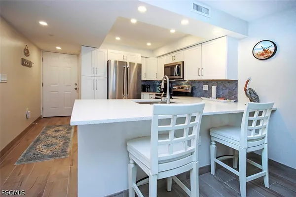 a large kitchen with a table and chairs