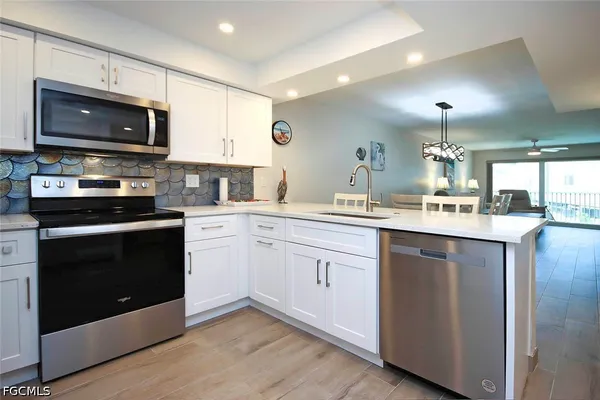 a kitchen with a sink stove and microwave