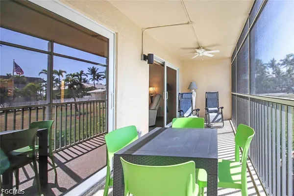 a view of a chairs and table in the balcony