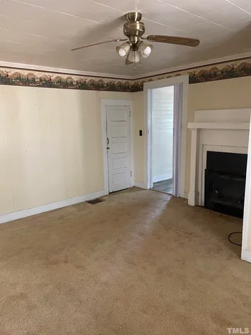 a view of an empty room with a fireplace