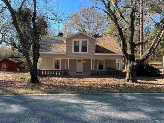 a house that has a tree in front of it