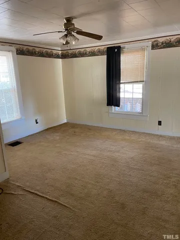 a view of a room with window and a ceiling fan