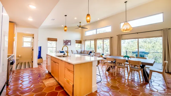 a very nice looking dining room with a large dining table and a large window with garden view