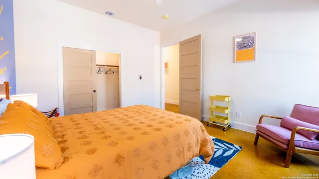 a bedroom with a bed and a chair