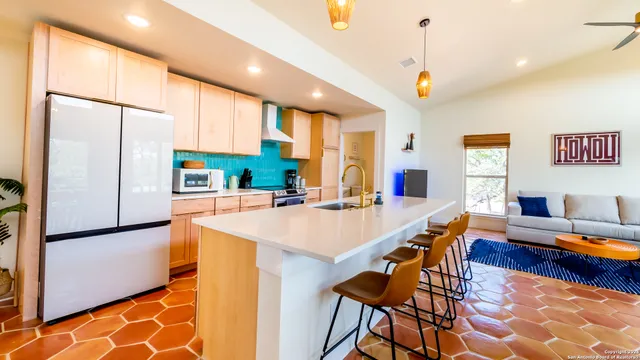 a large kitchen with a table and chairs