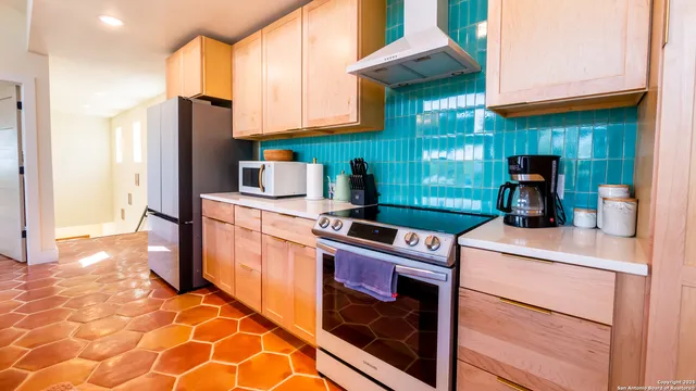 a kitchen with a stove cabinets and a refrigerator