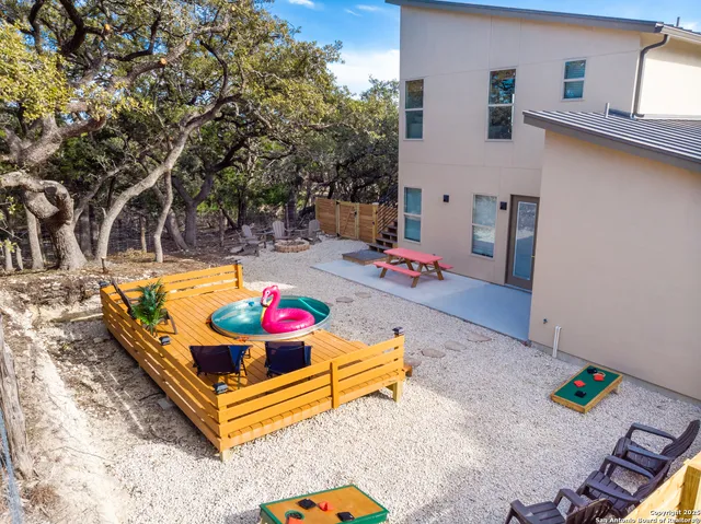 a view of a backyard with a table and chairs