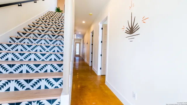 a view of a hallway with wooden floor