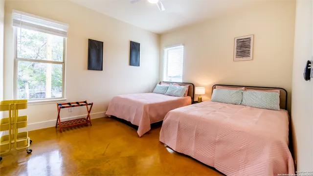 a bedroom with two beds and a couch