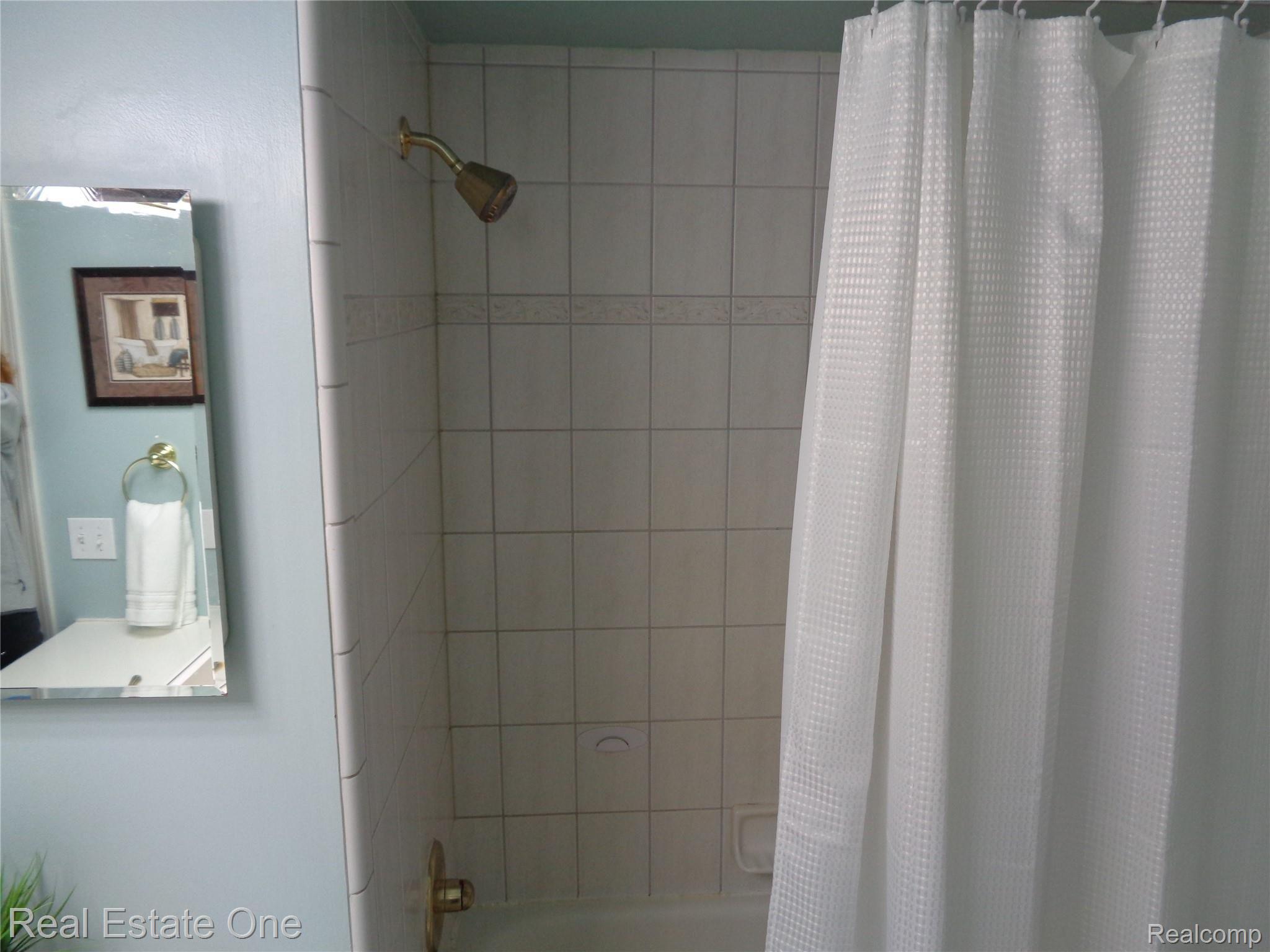 2572 Lake George Road Oakland, MI 48363 - Photo 44 of 83 with ceramic tub surround and brand new (never used) shower curtains