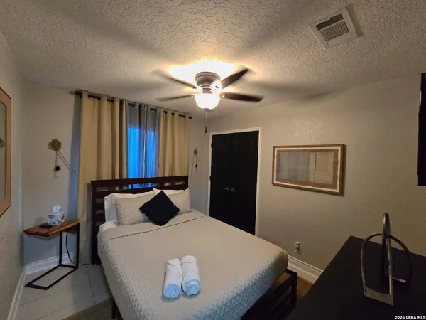 a bedroom with a bed and a chandelier
