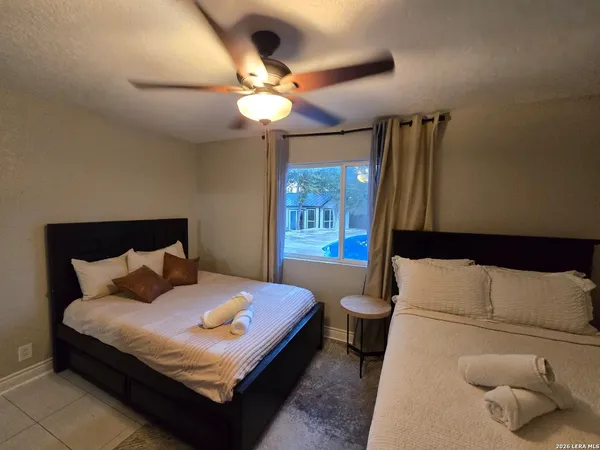 a bedroom with a large bed and a chandelier