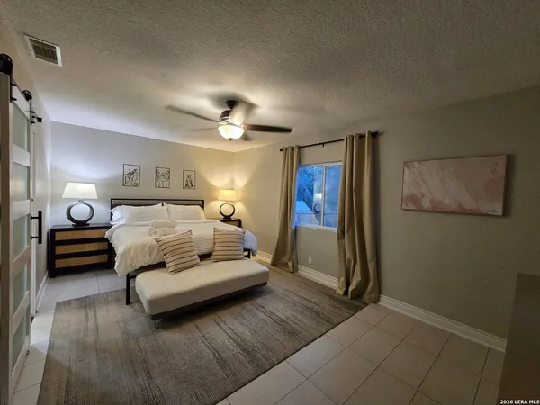 a living room with furniture and a mirror